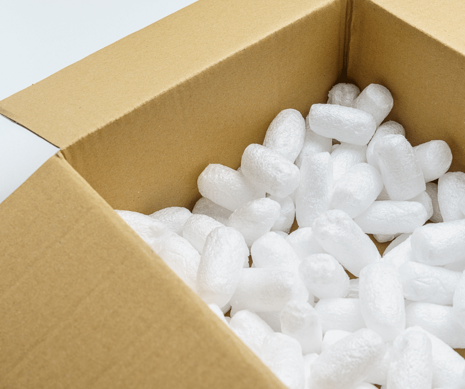 Assorted packing peanuts filling a box to prevent damage during moving